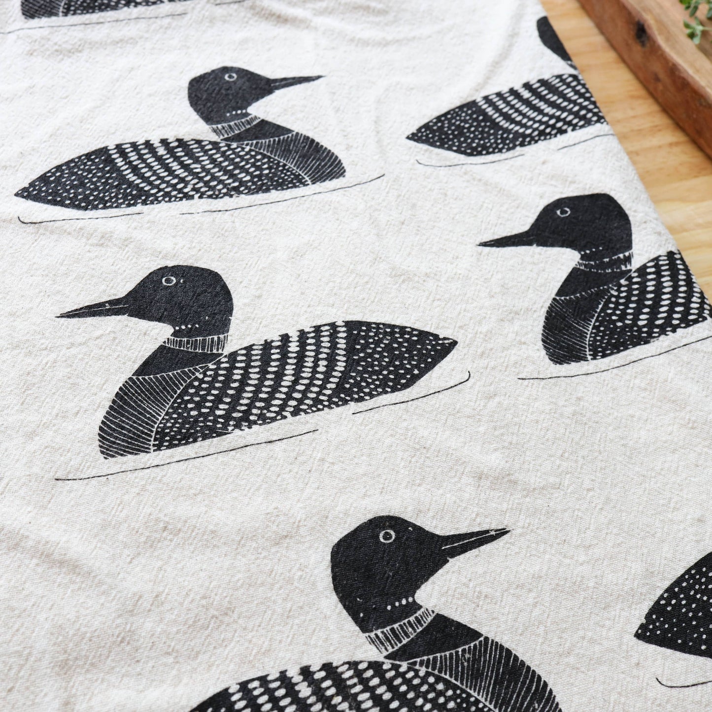 Fabric with black and white duck pattern on a light background