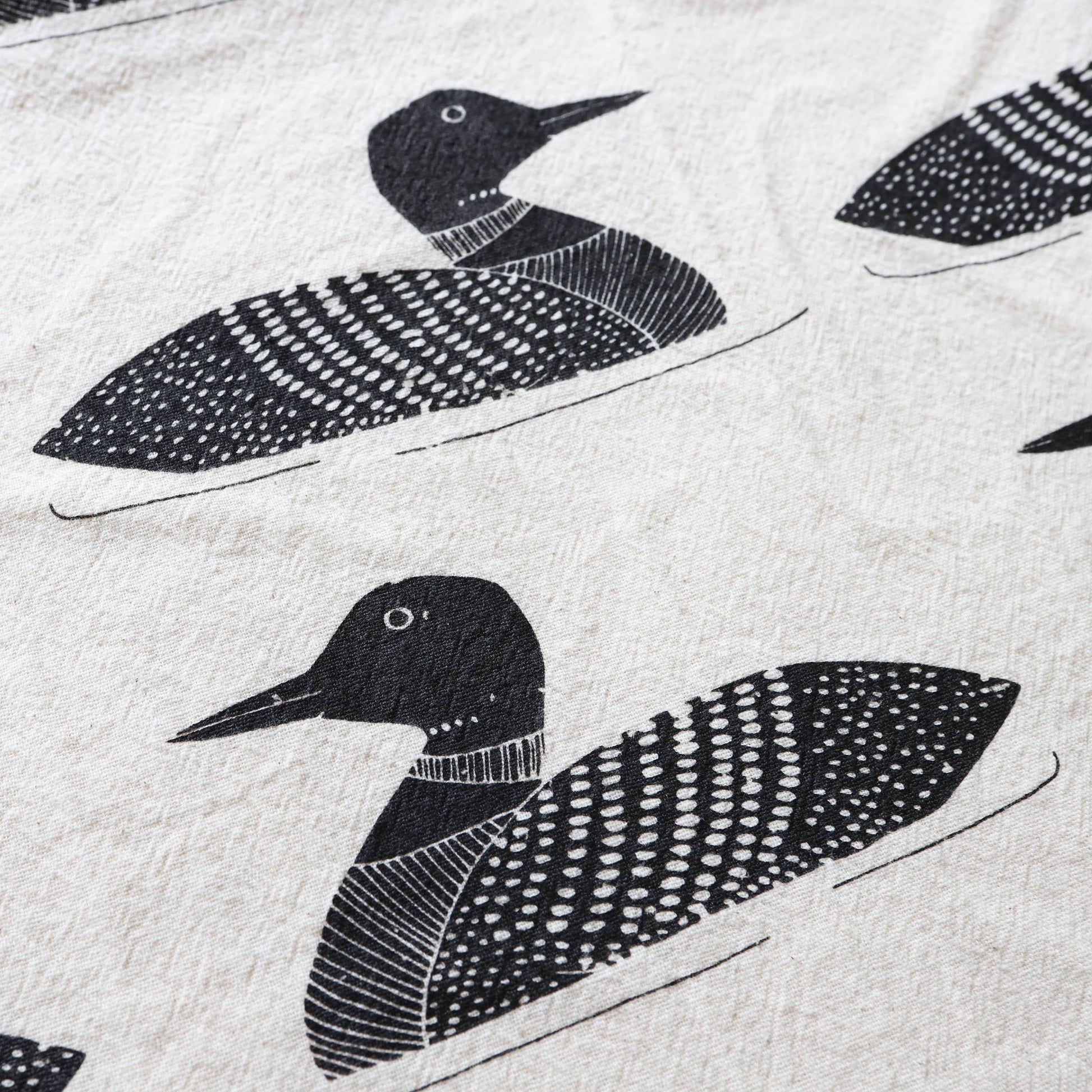 Pattern of black loon birds on a light gray background