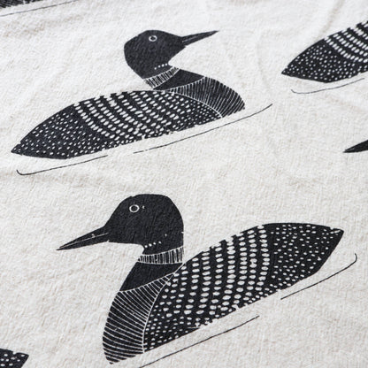 Pattern of black loon birds on a light gray background