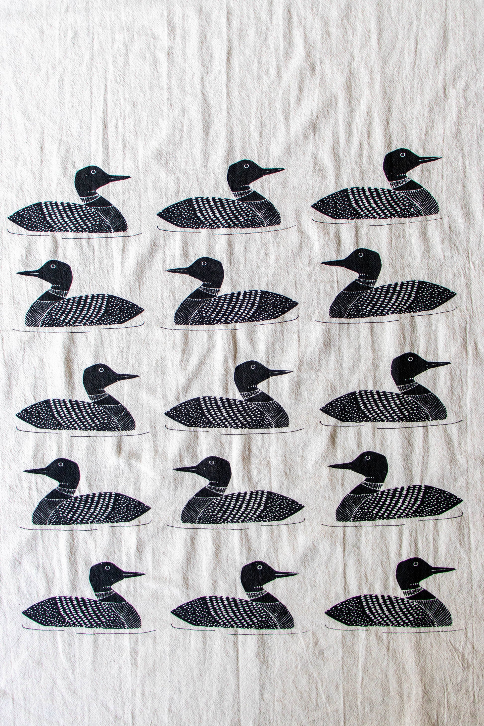 White towel with black loon bird pattern