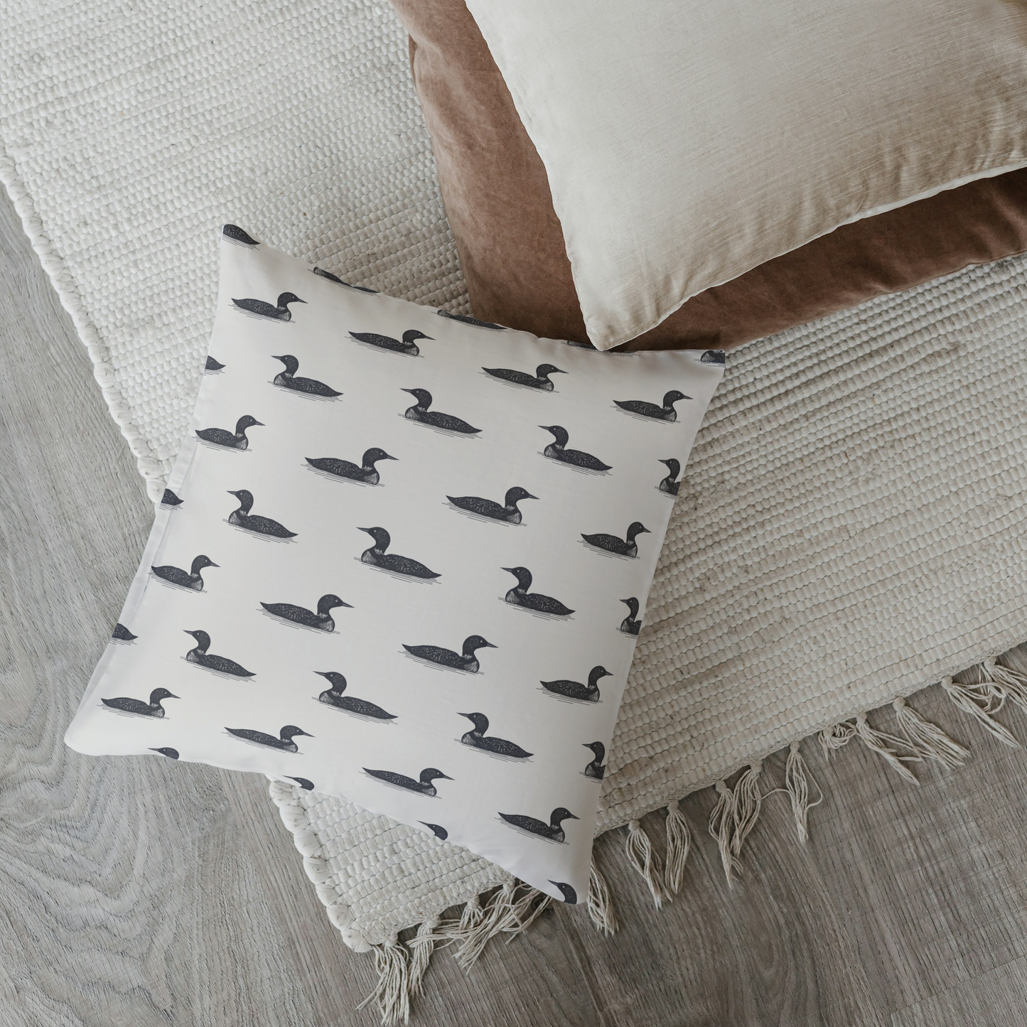 Decorative pillow with duck pattern on a textured surface