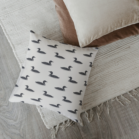 Decorative pillow with duck pattern on a textured surface
