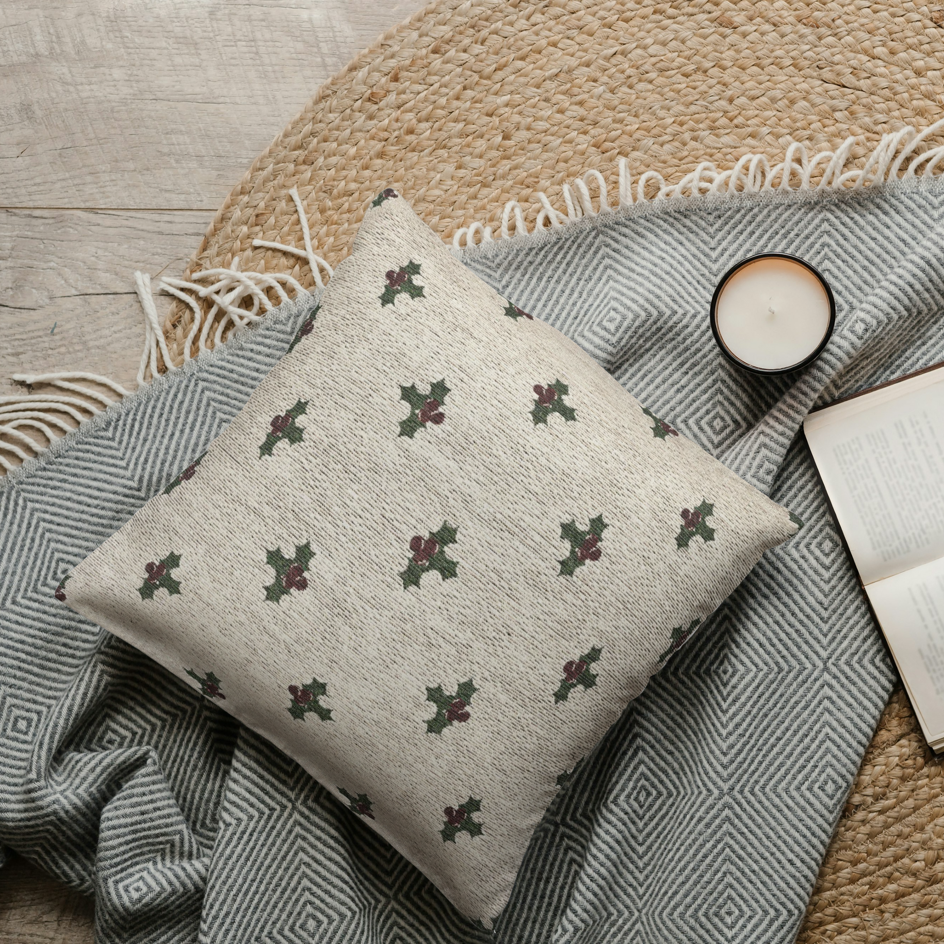 Decorative pillow with geometric pattern on a textured surface with a book and candle.
